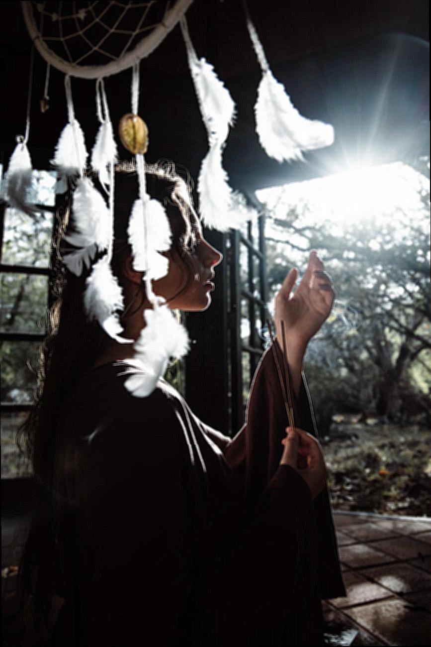 Girl in Long Clothes in Shed with Shamanic Accessories
