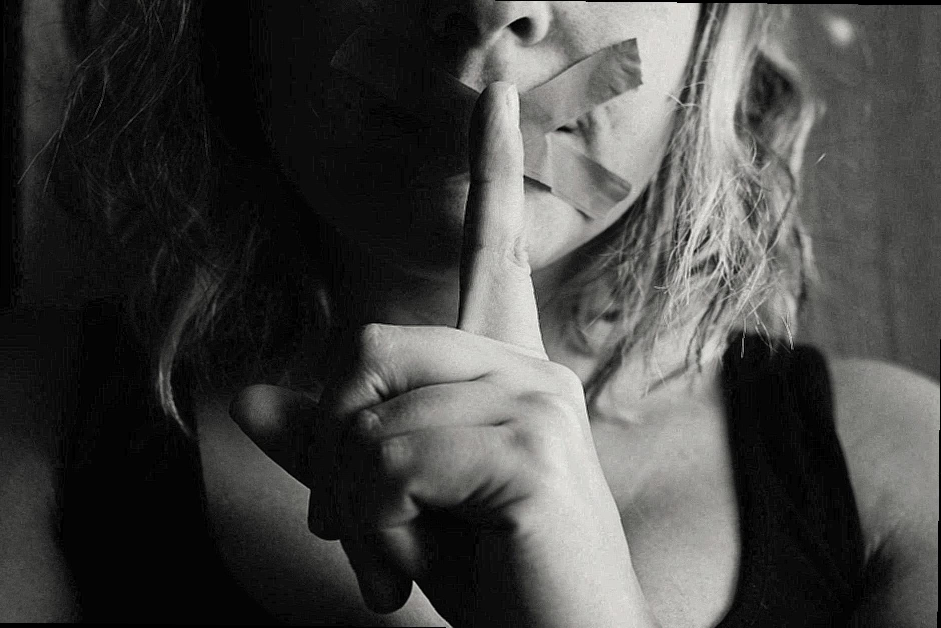 Woman Placing Her Finger Between Her Lips