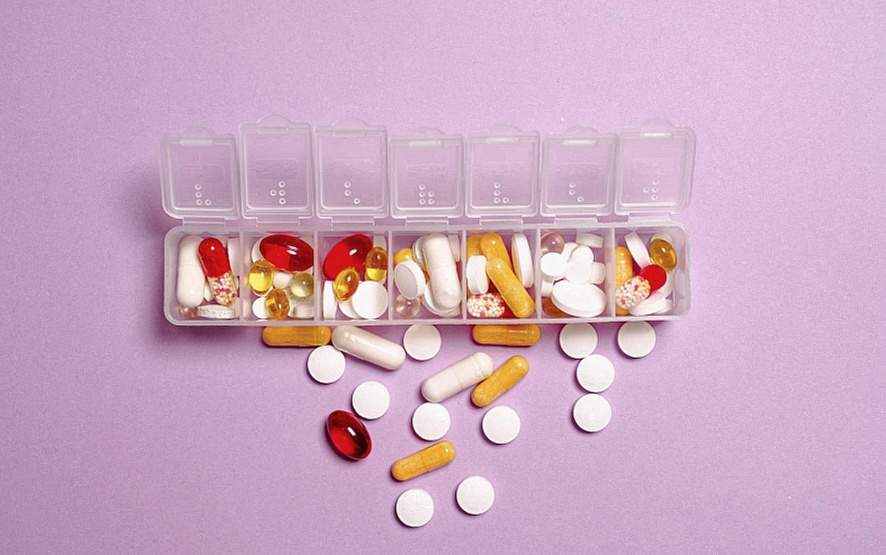 Photo Medication Pills on White Plastic Container