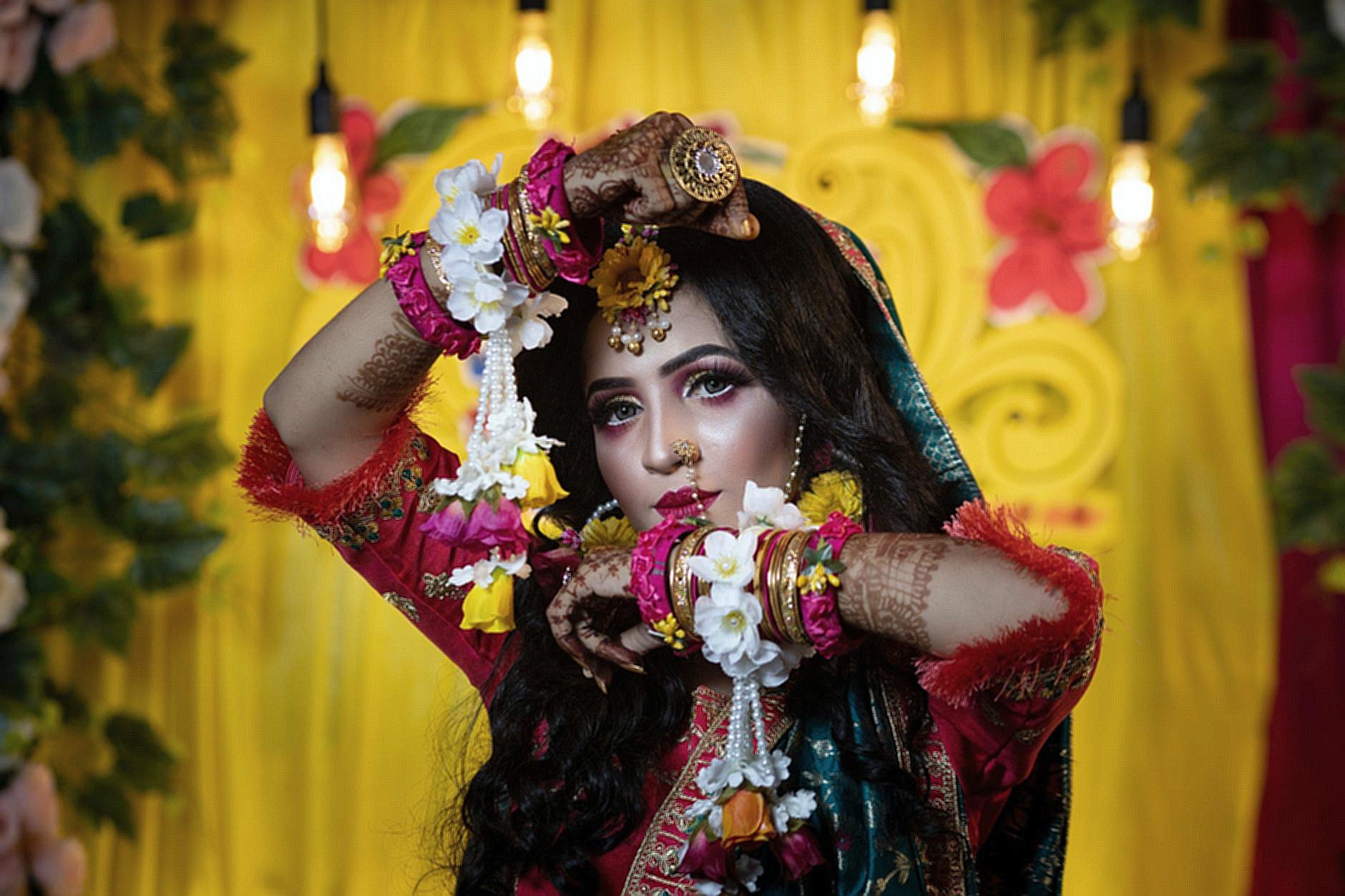 Photo of a Brunette Woman Wearing Traditional Bracelets and Artificial Flower Decoration